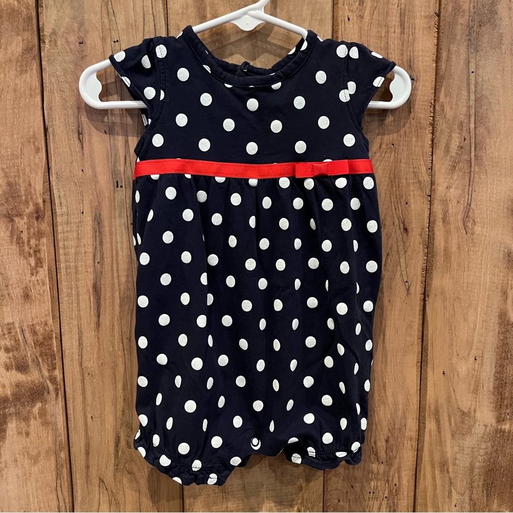 Navy polka dotted one piece with red ribbon